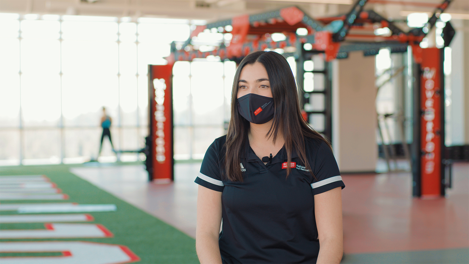 Masked student Gillian Torr in the gym of the new Wellness and Recreation Center