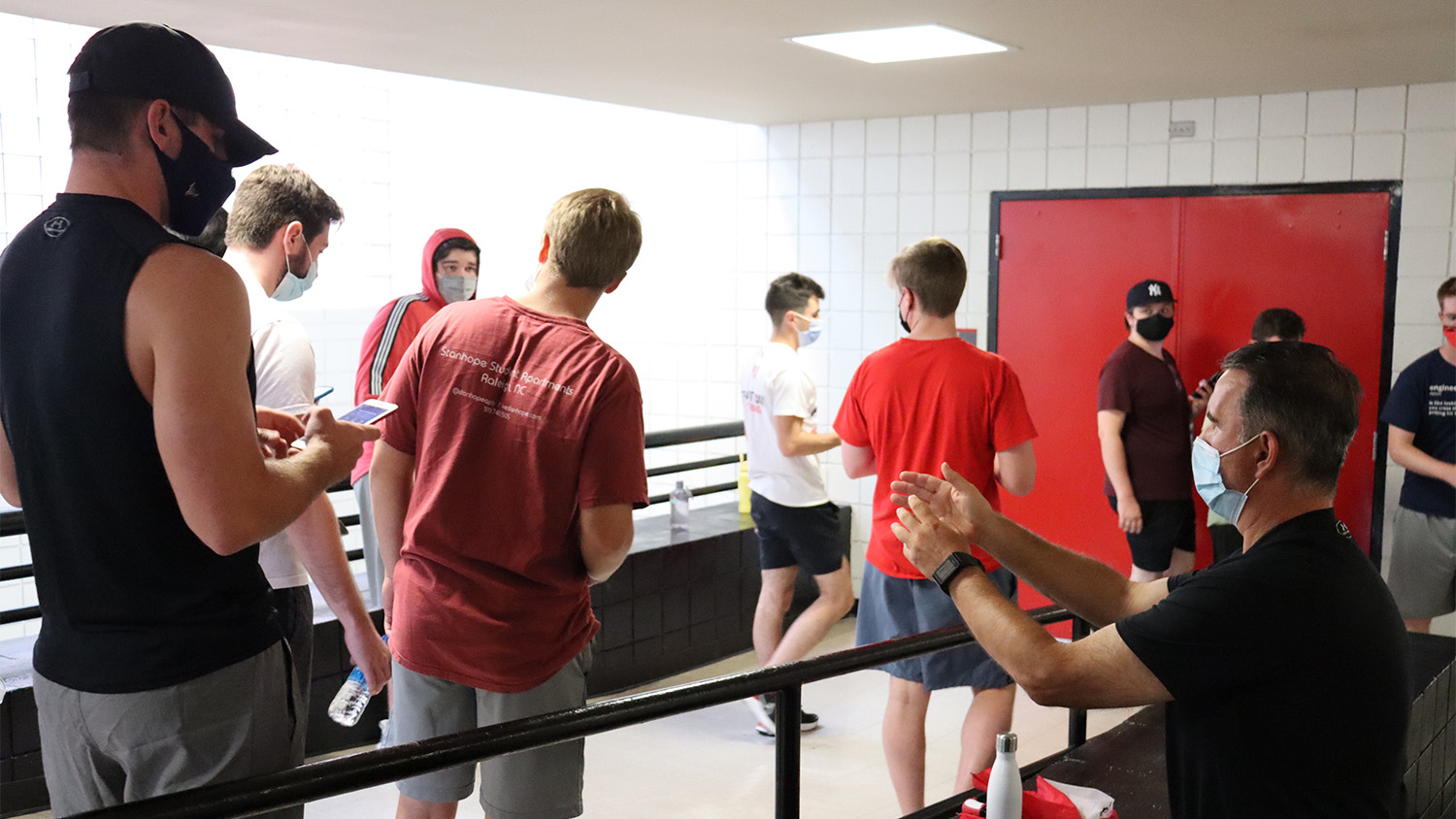 Professor Peter Koutroumpis talks to students in his Fitness Walking class.