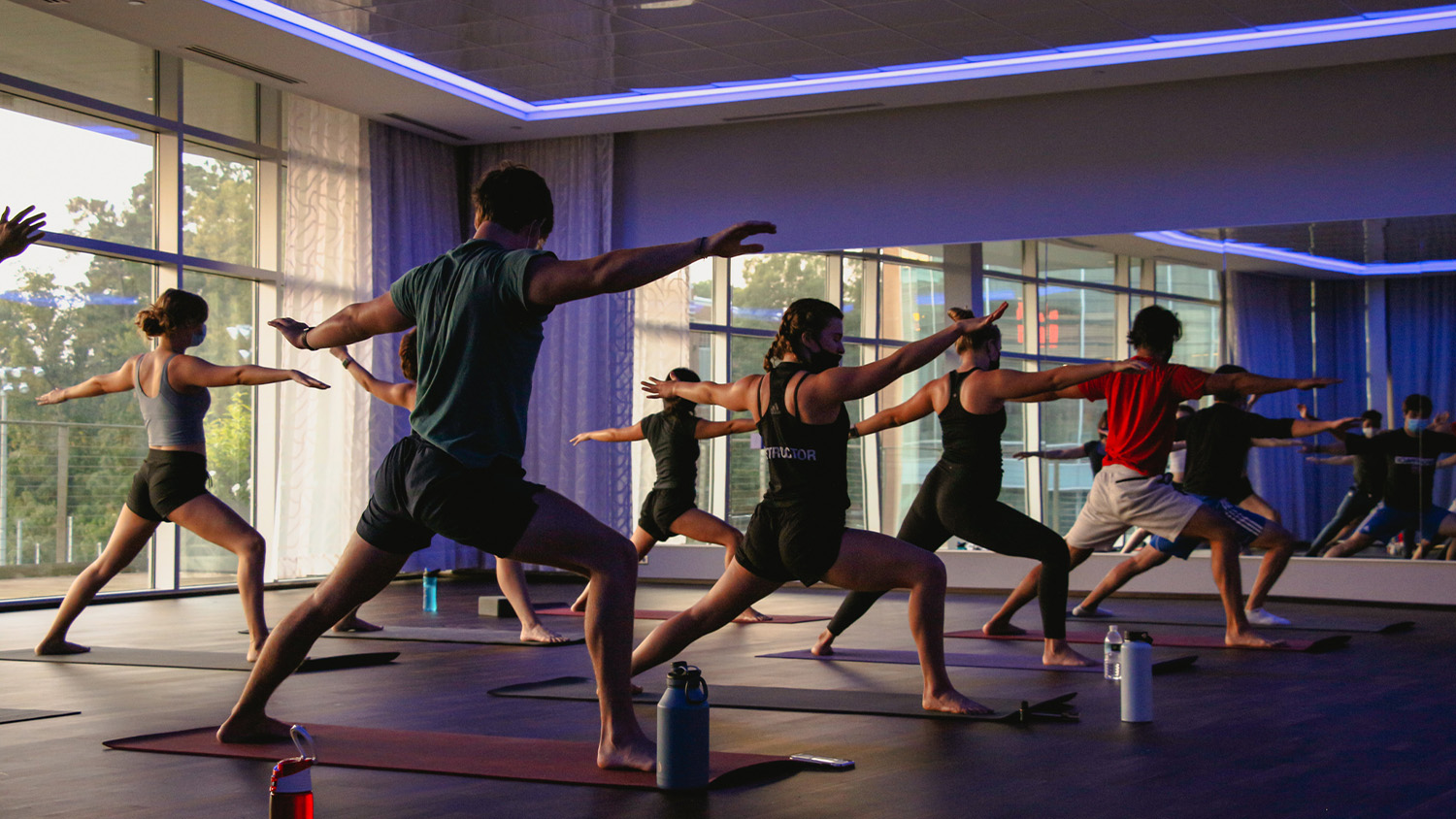 Students perform yoga poses in a group class