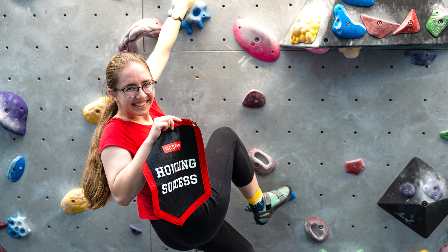 Among her many on-campus endeavors, Rosie Maloney works at Wellness and Recreation's climbing wall.
