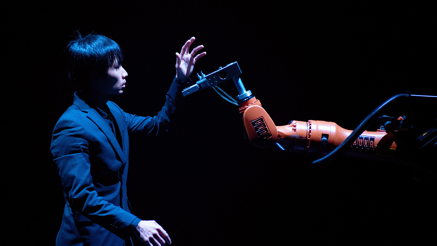 Huang Yi and his specially programmed robot, Kuka, during his signature performance.