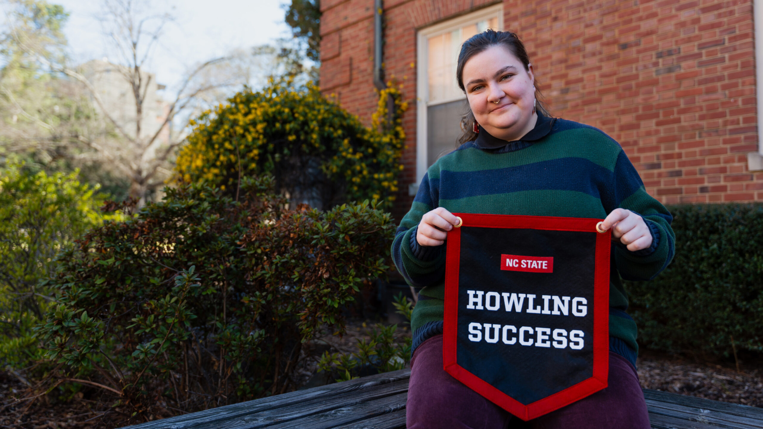 Bee Mangine proudly displays their Howling Success banner.